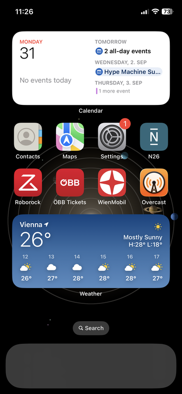 A homescreen on iOS showing the following apps: Contacts, Apple Maps, Settings, N26, Roborock, Austrian Railway Ticket App, Vienna Public Transport App, Overcast. There's a calendar widget in the top and a weather widget in the bottom. The favourites bar is empty.